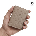 Beige slim wallet with embossed monogram pattern