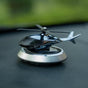 Solar powered helicopter car aroma diffuser on dashboard